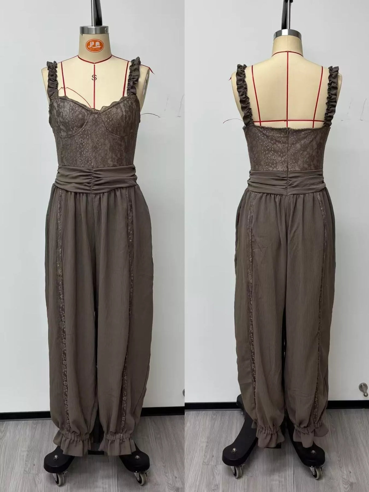 Dark gray lace corset jumpsuit, front and back views with draped harem pant fit