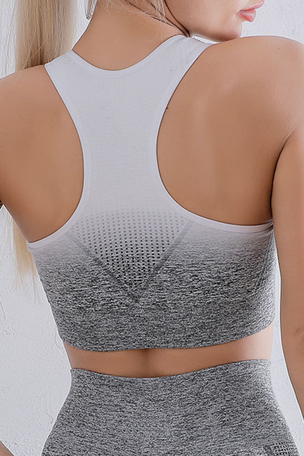 Grey gradient racerback sports bra with scoop back and perforated front panel