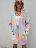 Pastel rainbow gradient open-front cardigan with long sleeves and front pockets, fuzzy knit.