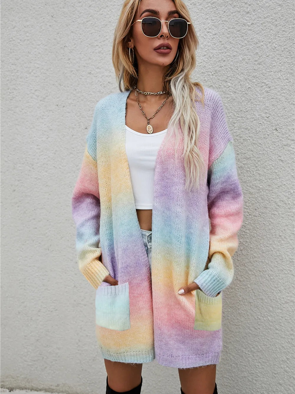 Pastel rainbow gradient open-front cardigan with long sleeves and front pockets, fuzzy knit.