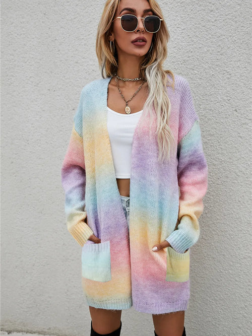 Pastel rainbow gradient open-front cardigan with long sleeves and front pockets, fuzzy knit.