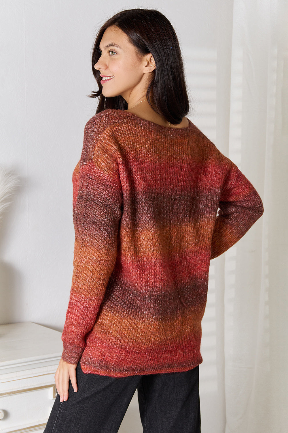 Gradient knit sweater in brick red to orange, long sleeves, back view