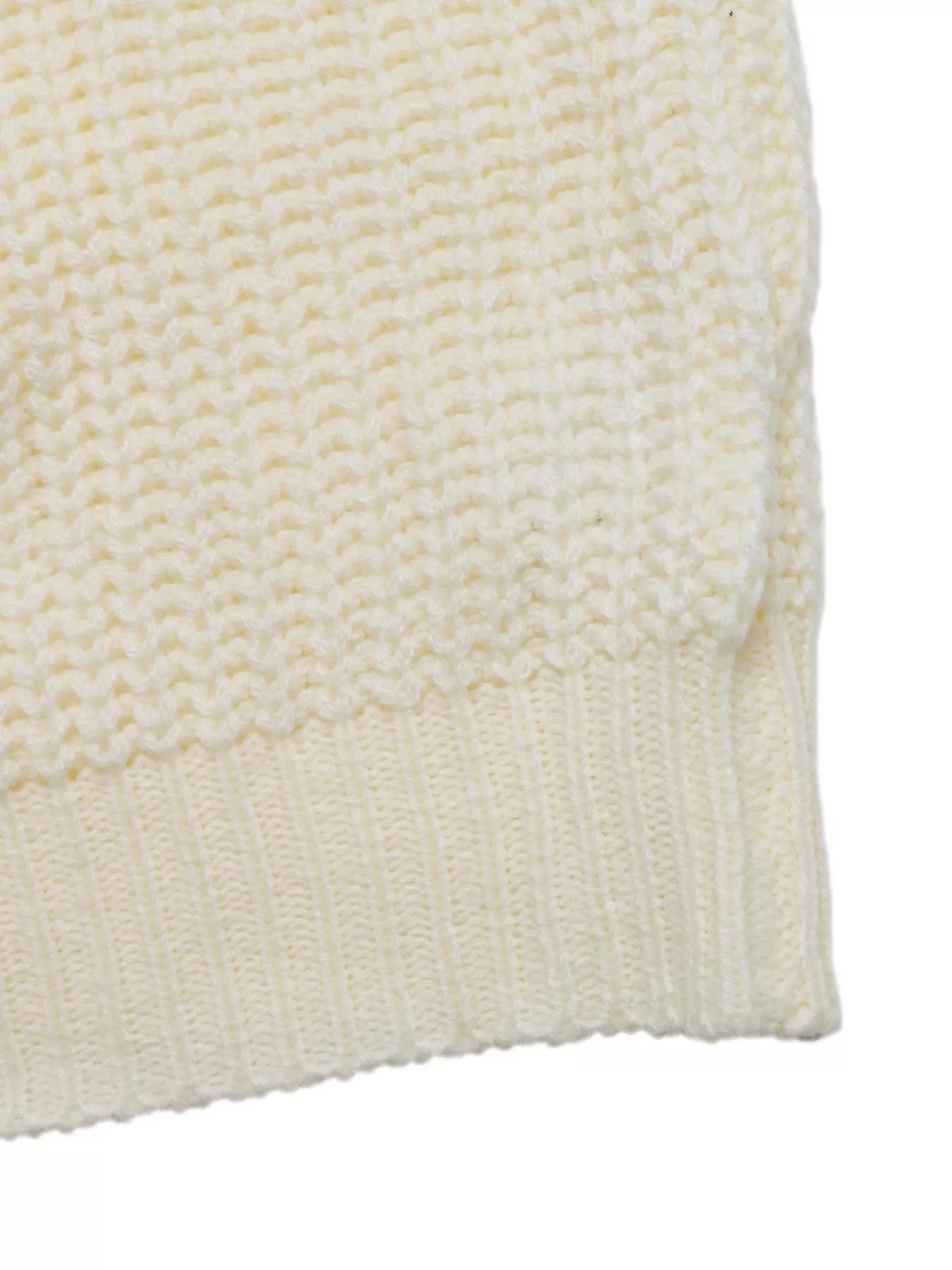 Ivory ribbed knit hemline on a long sleeve sweater