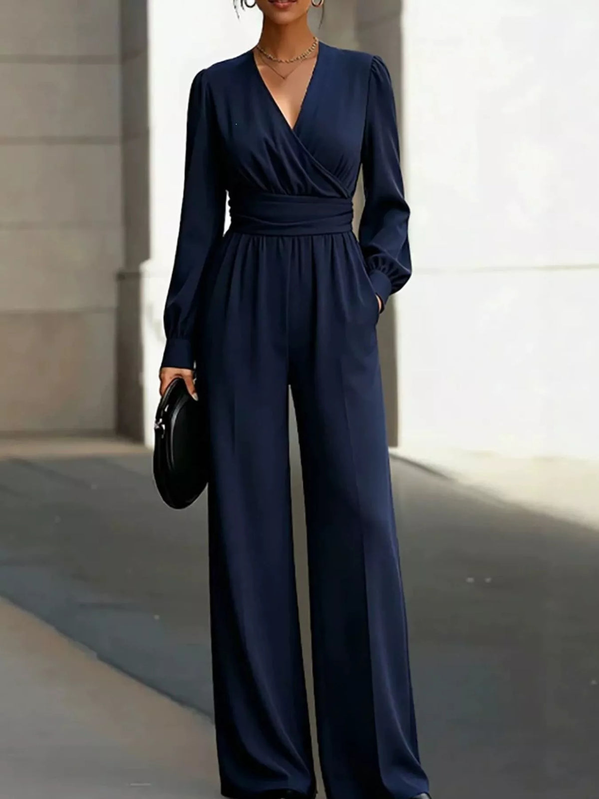 Navy surplice wide-leg jumpsuit with long sleeves and side pockets