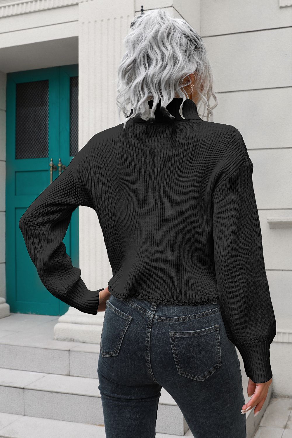 Black turtleneck dropped-shoulder sweater, back view, cuffed long sleeves, ribbed knit.
