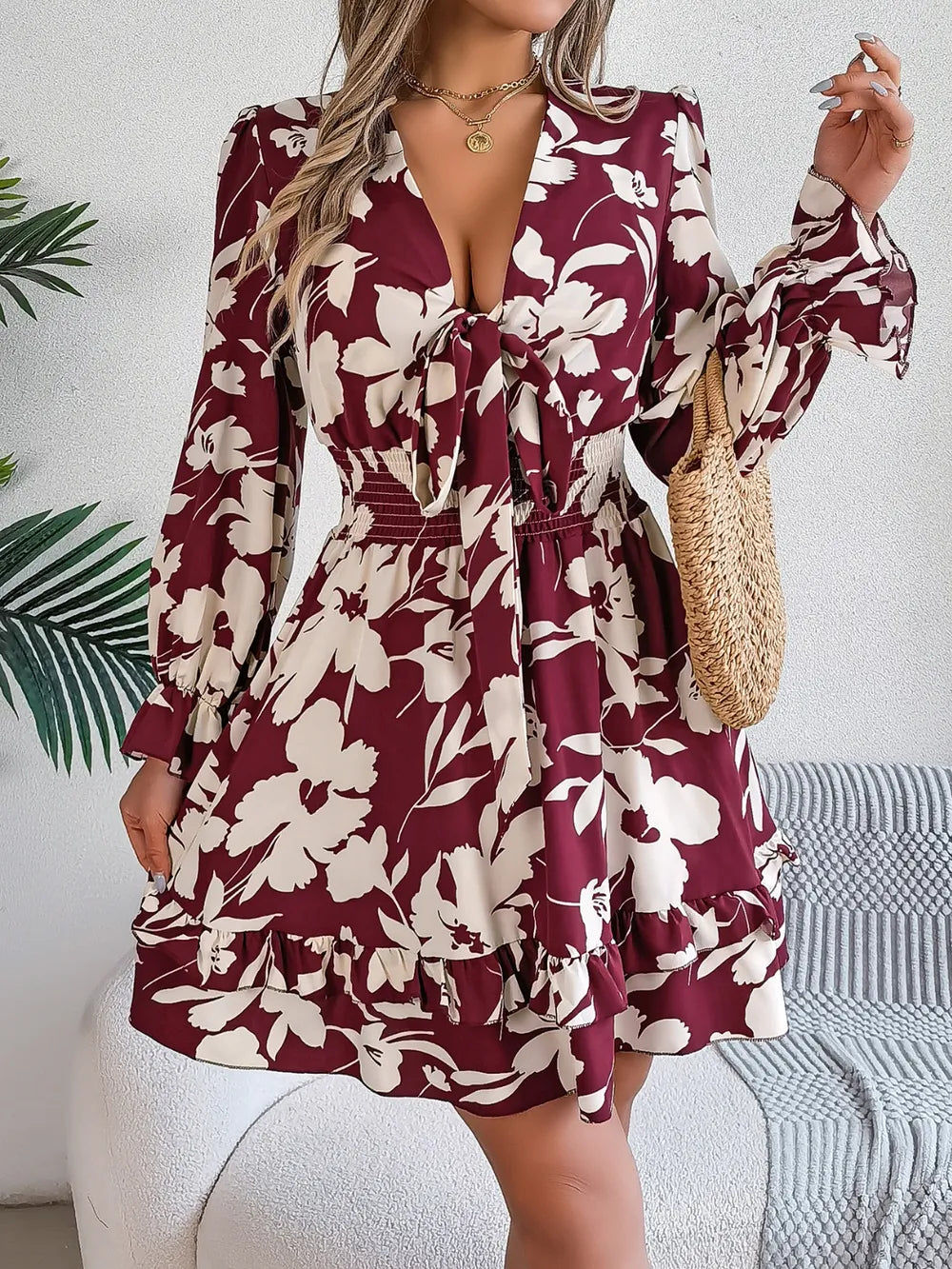 Burgundy floral long-sleeve dress with tie-front V-neck and ruffled tiered skirt