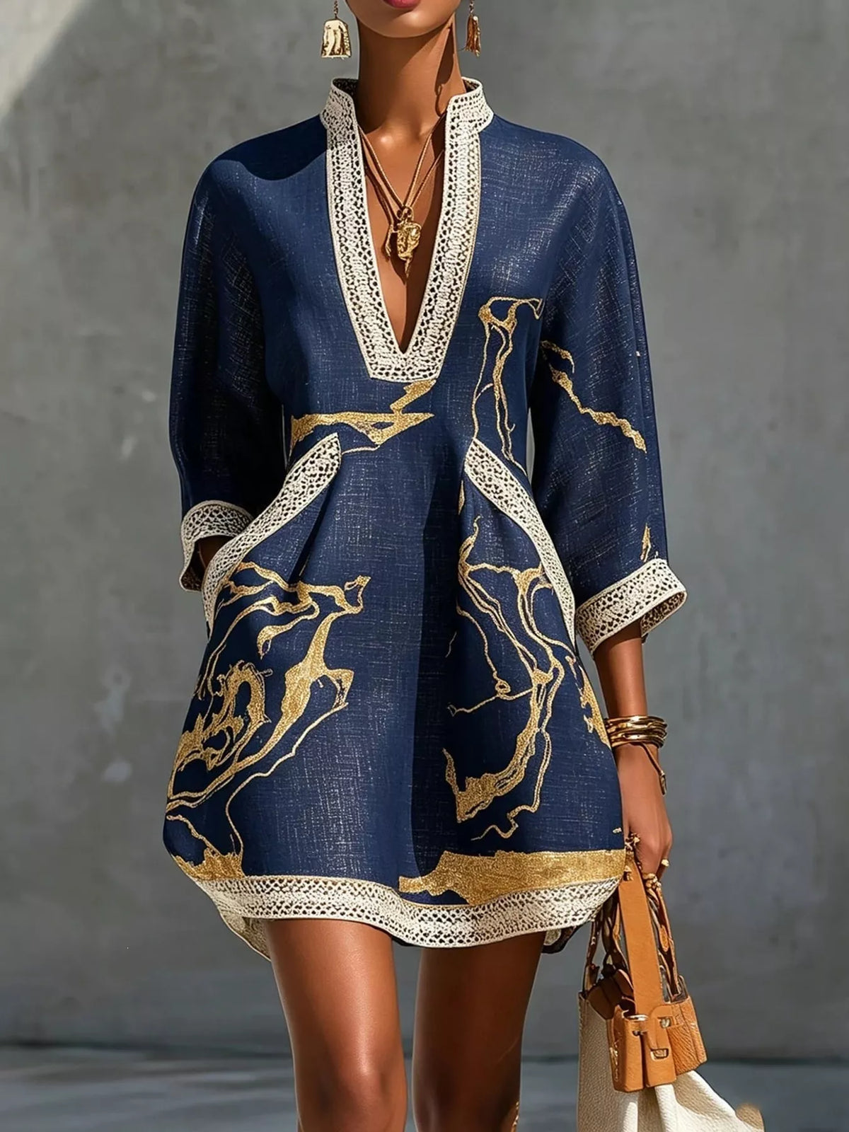 Navy mini dress with V-neck lace trim, three-quarter sleeves, and gold patterned print