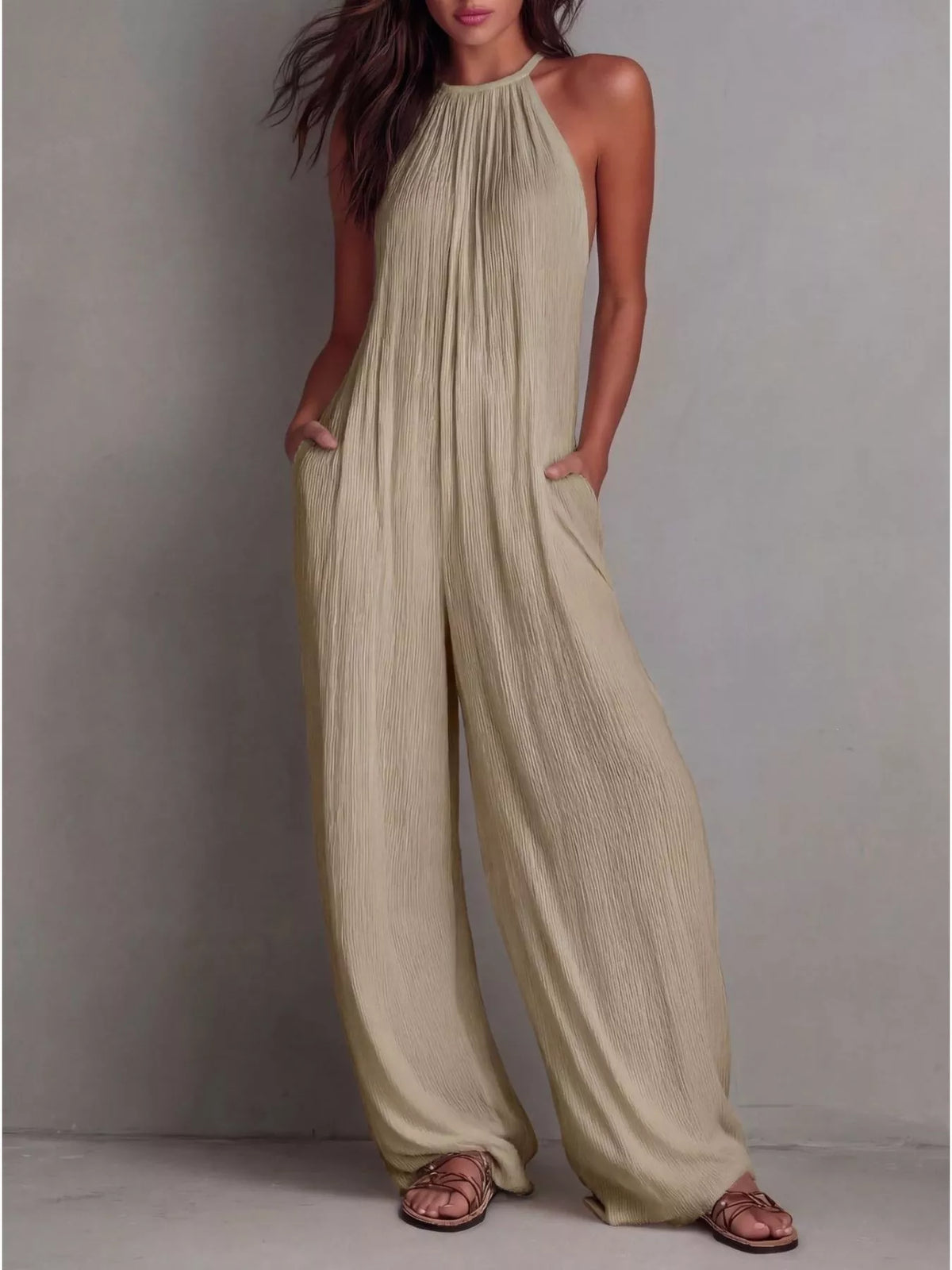 Sleeveless wide-leg jumpsuit in light khaki, halter neckline with pleated flow, wide pants