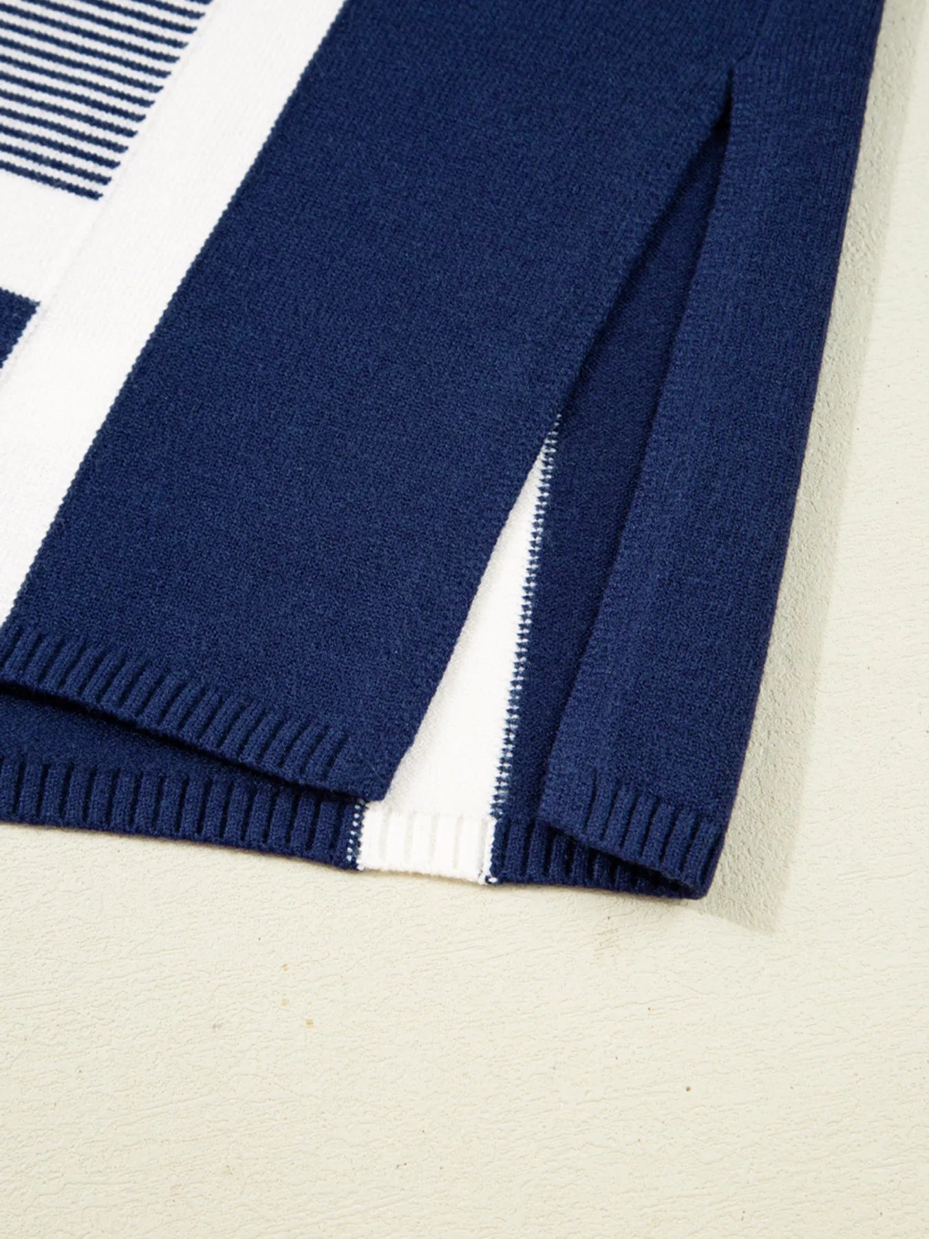 Navy and white striped knit tunic sweater with ribbed hem and side vent
