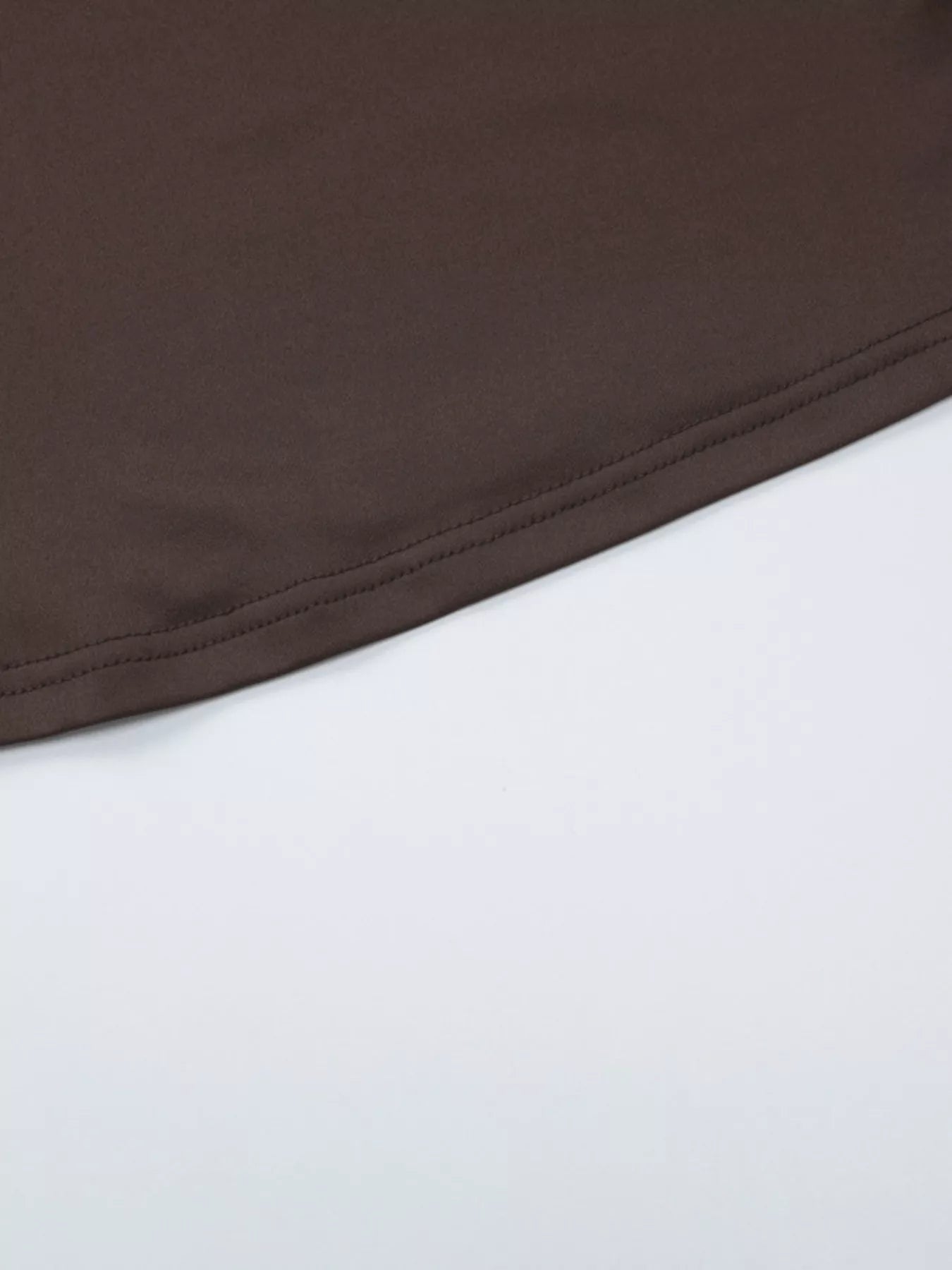 Dark brown crop top fabric with smooth stitched hem