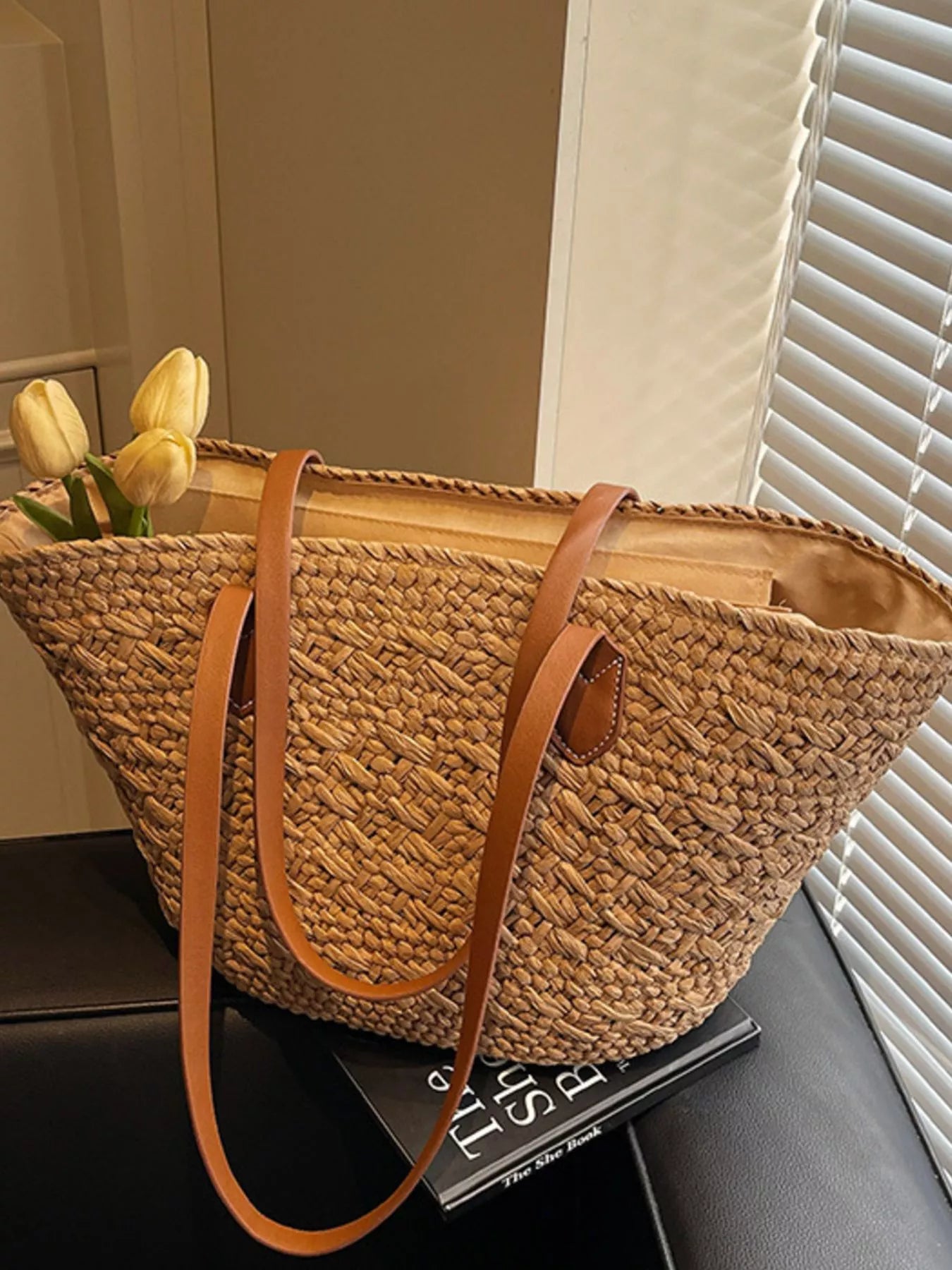 Caramel woven tote with brown leather crossbody strap and open top interior lining