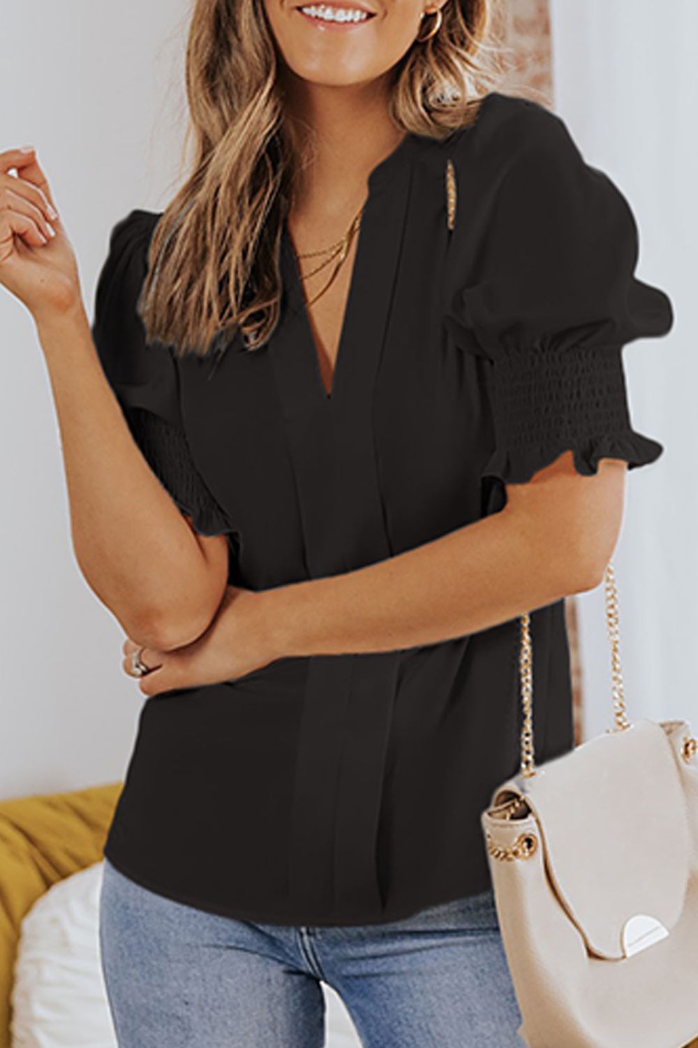 Smocked flounce sleeve blouse with notched V-neck, black short-sleeve puff shoulders
