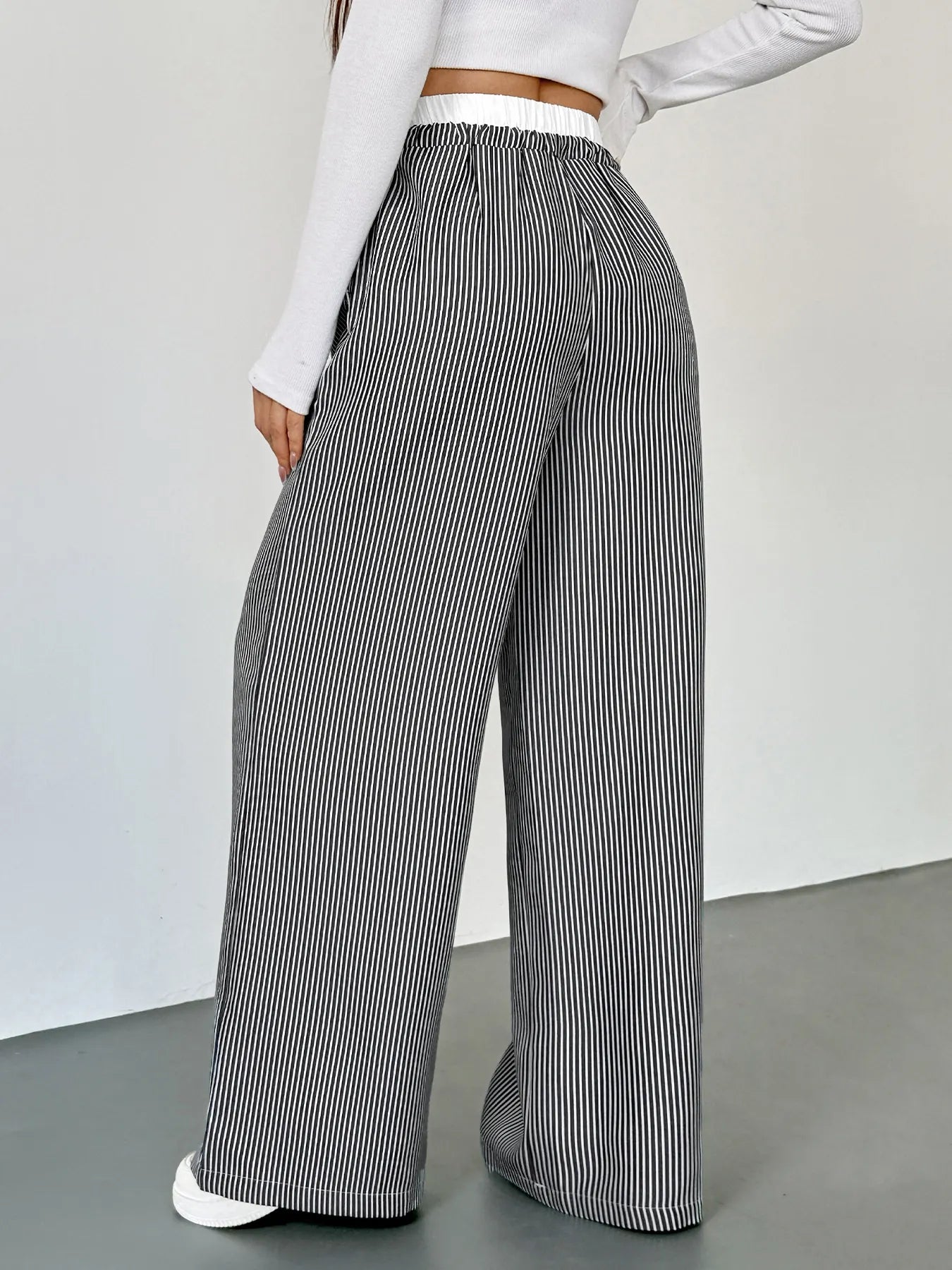 Striped wide-leg drawstring pants with side seam drape, black and white vertical stripes