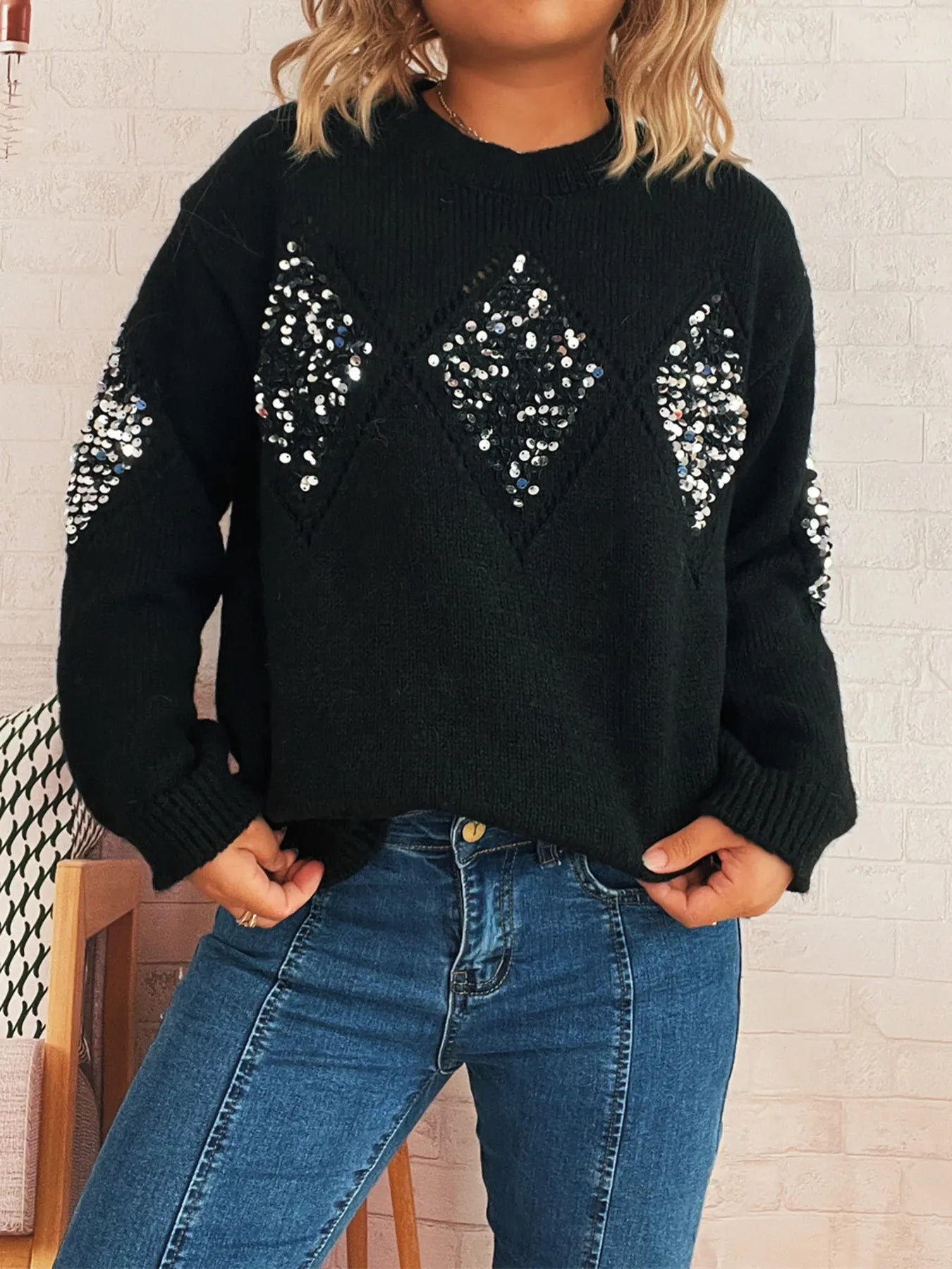Black oversized sweater with sequined diamond pattern on front and crew neckline