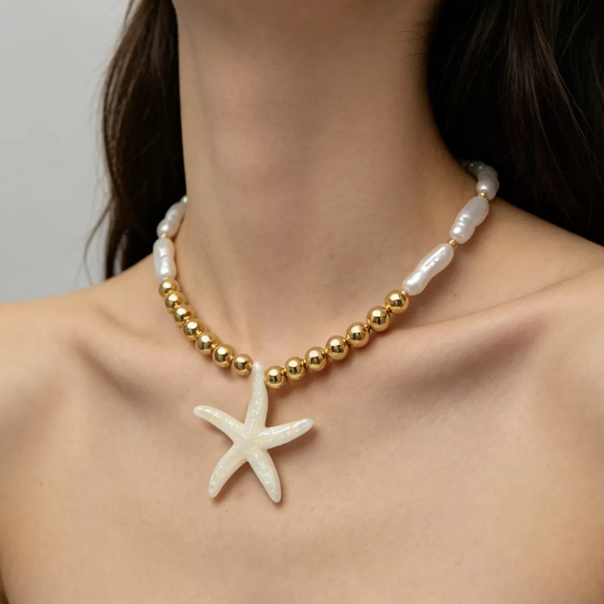 Starfish pendant necklace with pearl-look beads and gold-tone bead section