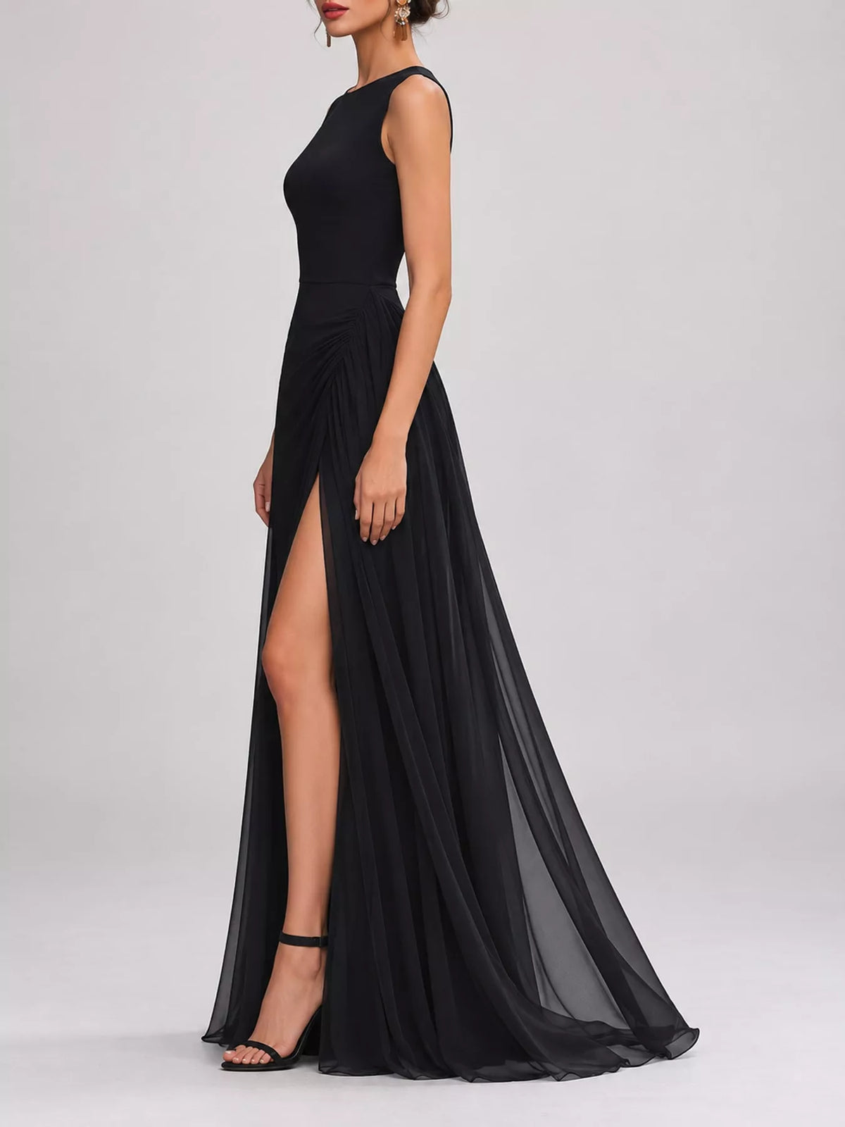 Black sleeveless maxi dress with high slit, fitted waist, and flowing chiffon hem.