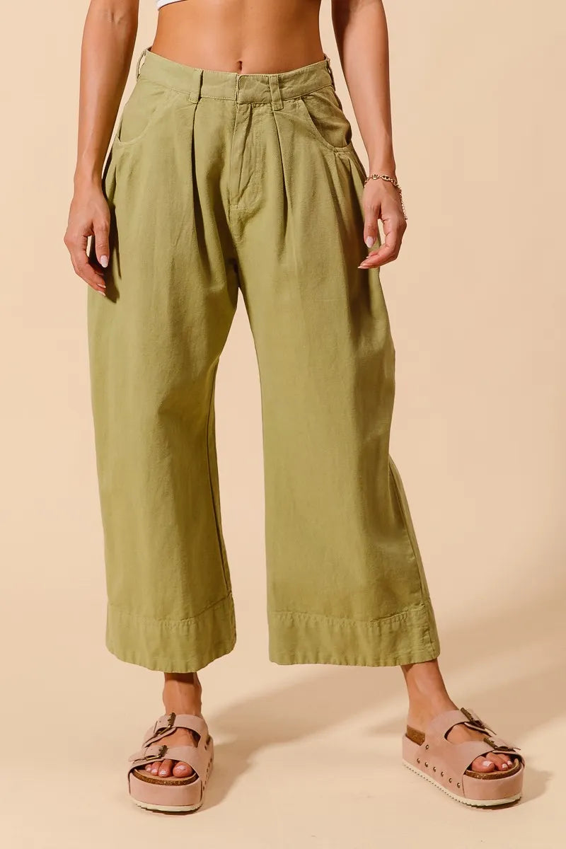 Sage green mid-rise wide-leg chino pants with side pockets and pleated waist