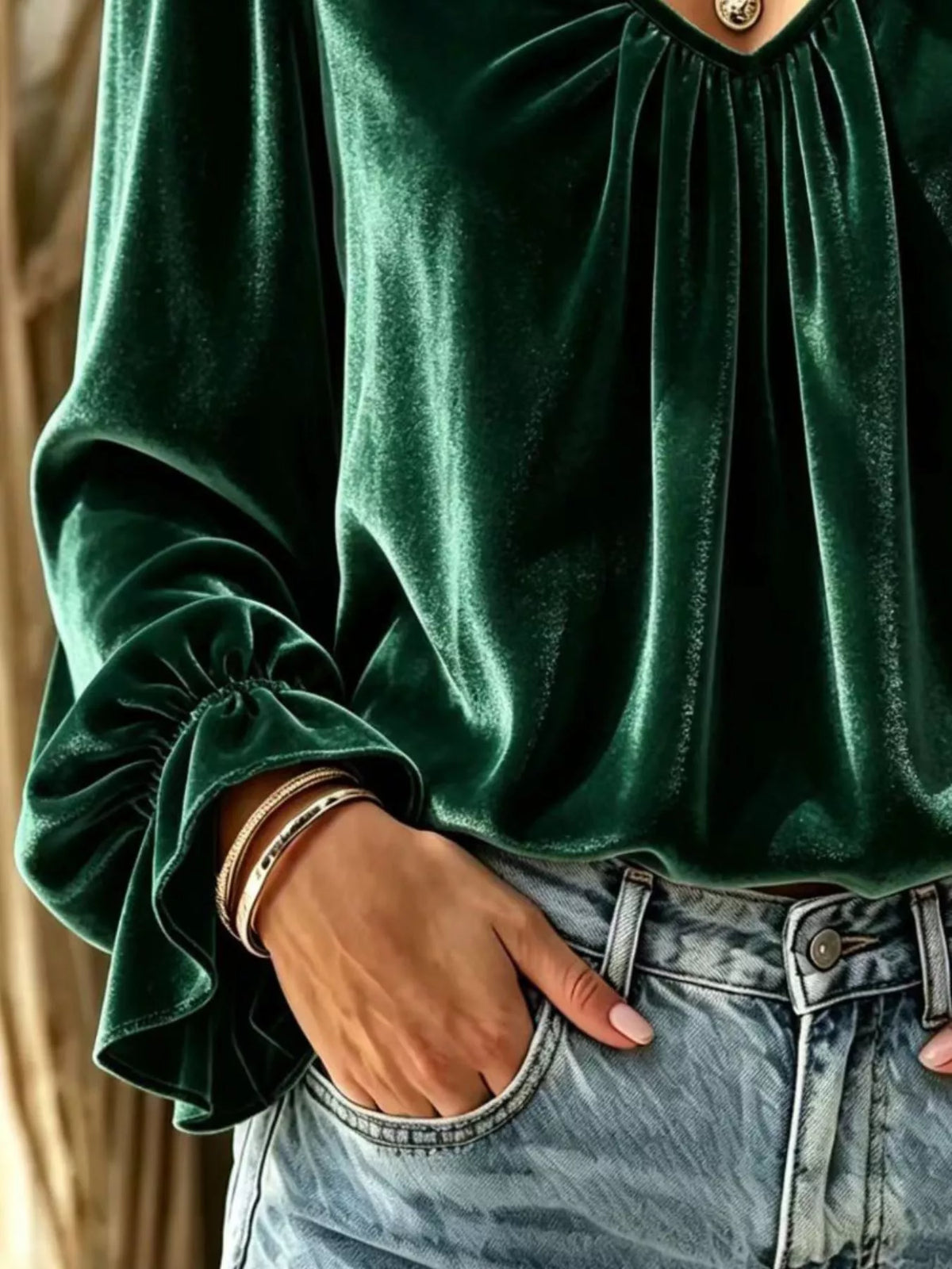 Dark green velvet blouse with ruched V-neck and gathered sleeve cuff