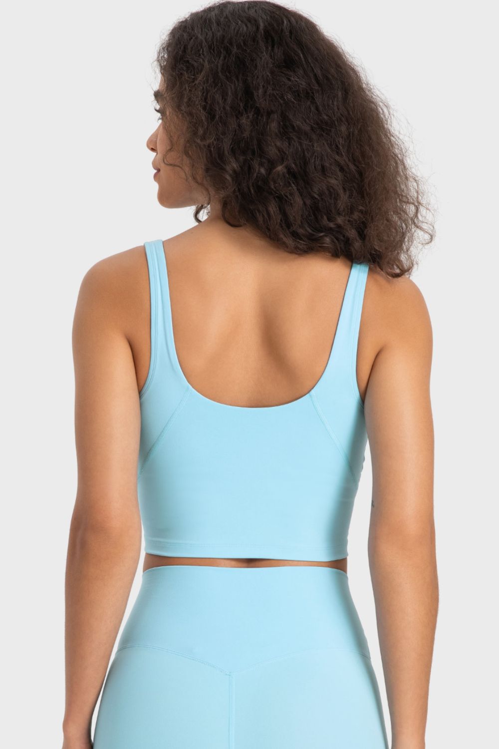 Deep V-neck crop sports bra, light blue color, back view with racerback straps.
