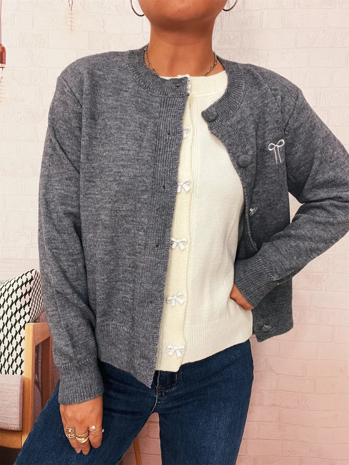 Dark gray button-up long sleeve cardigan with knit texture and button front.
