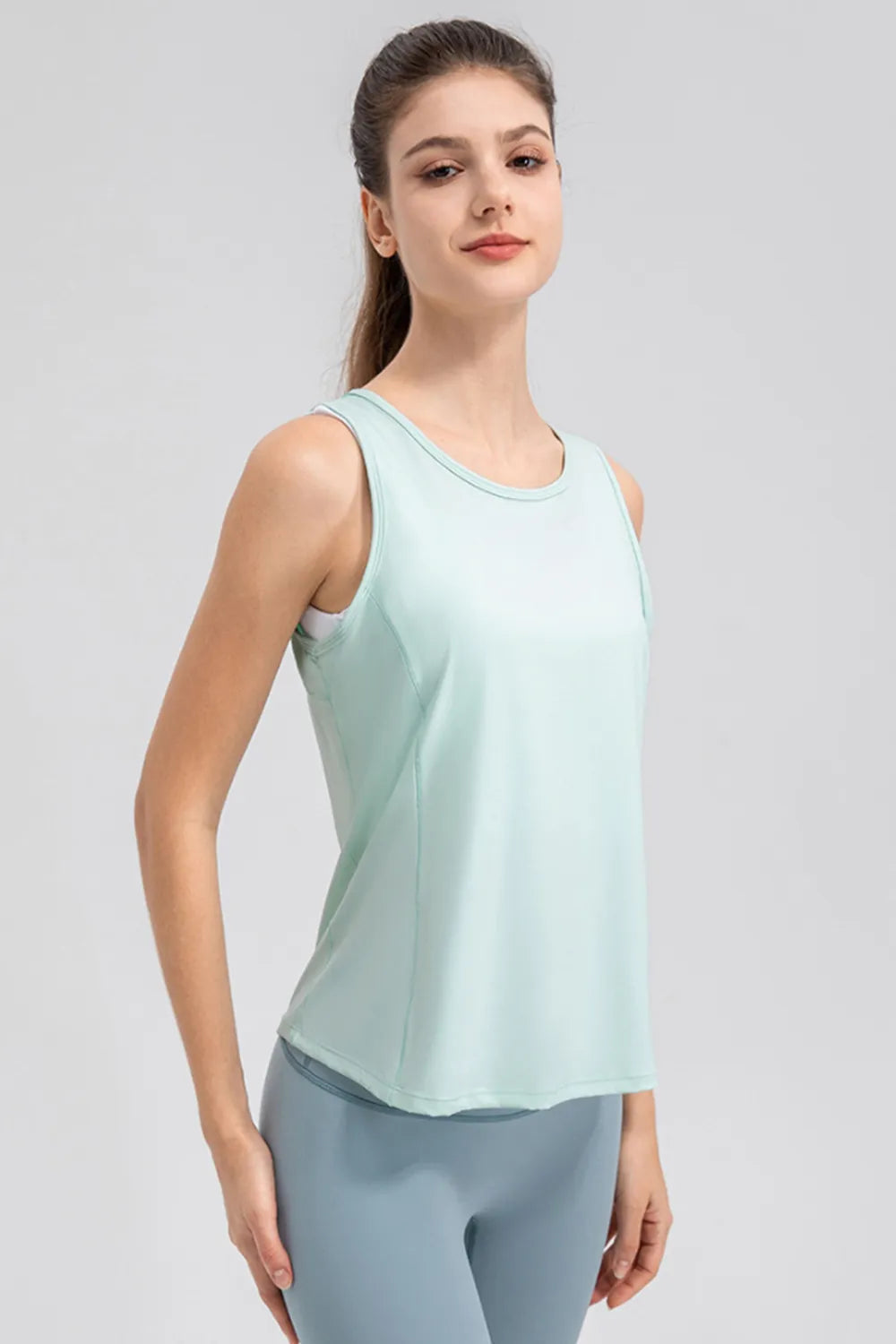 Women’s aqua active tank top with wide straps and curved hem