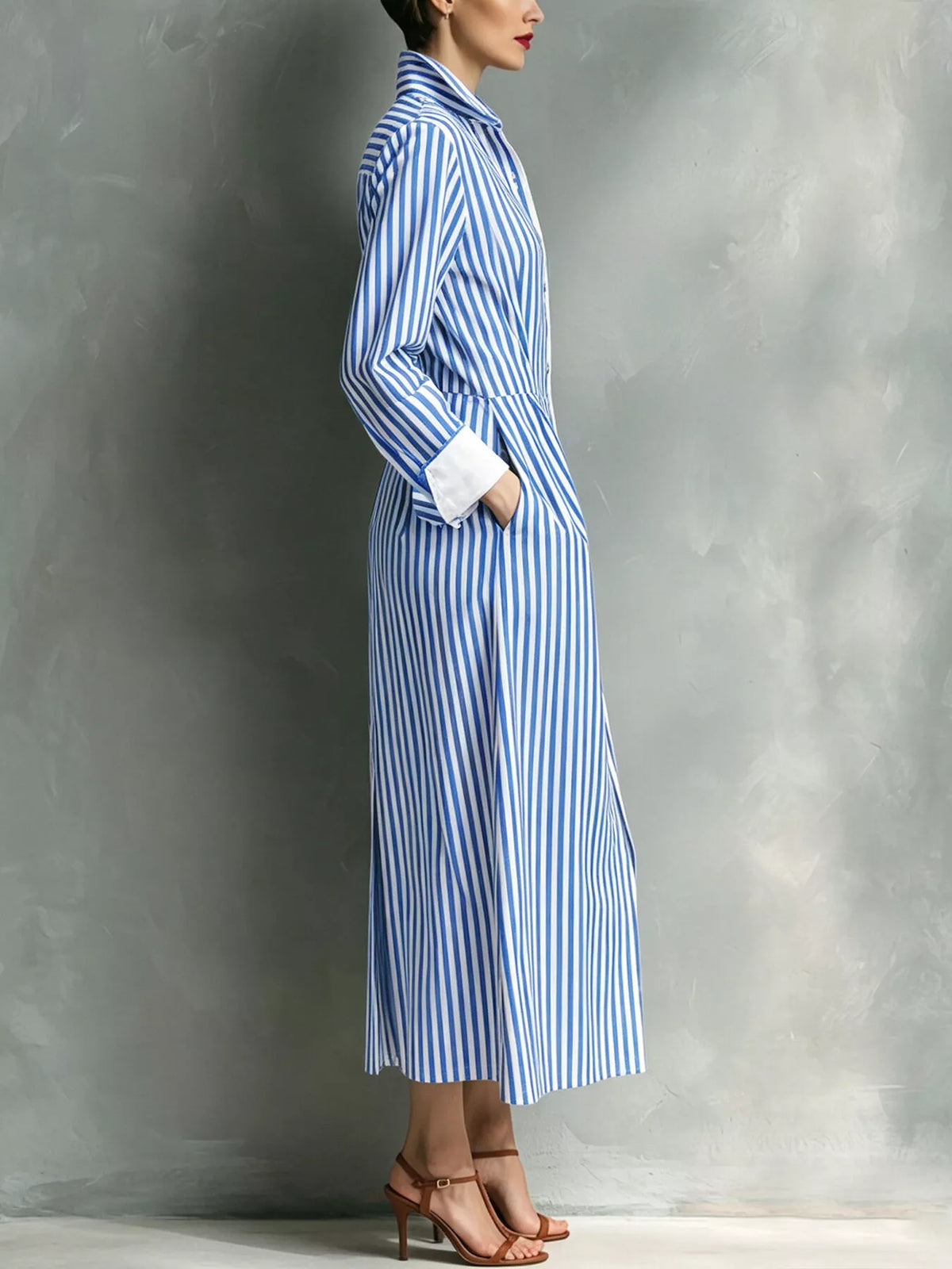 Blue striped shirt dress with button-front and pointed collar, side view, midi length.
