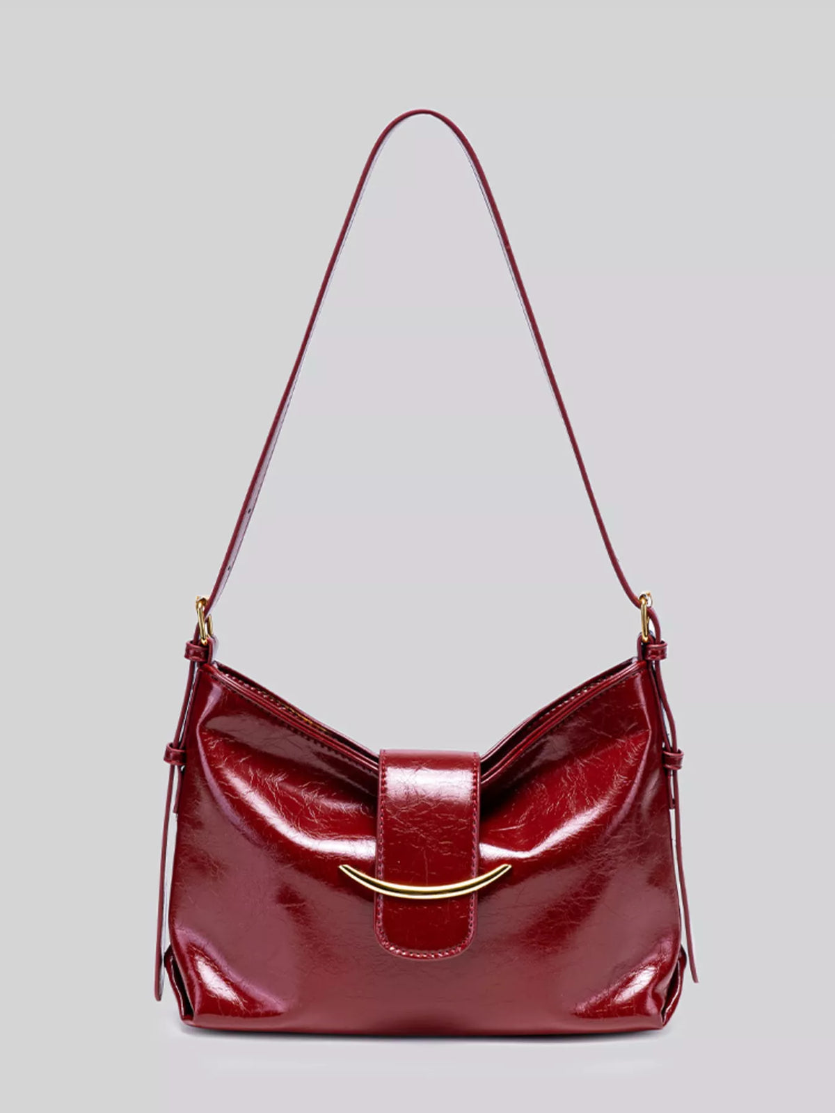 Wine red gloss vegan leather crescent shoulder bag with magnetic snap and strap