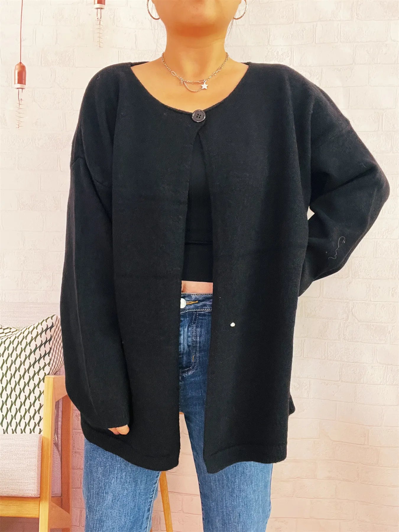 Black oversized one-button drop-shoulder cardigan with long sleeves and crew neck