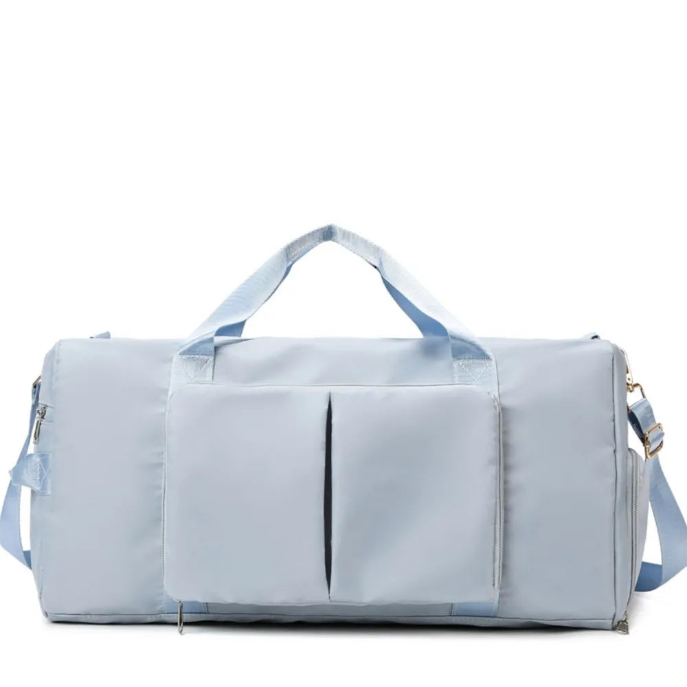 Large travel duffel bag with front zip pocket, light blue body and side carry straps