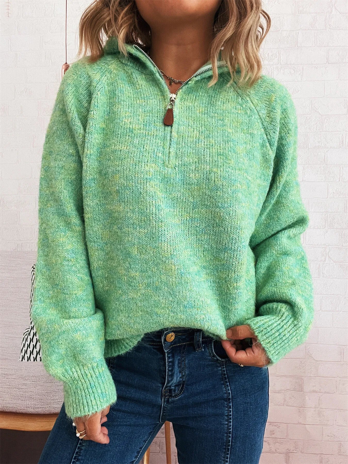 Green quarter-zip knit sweater with ribbed hem, cuffs, and long sleeves