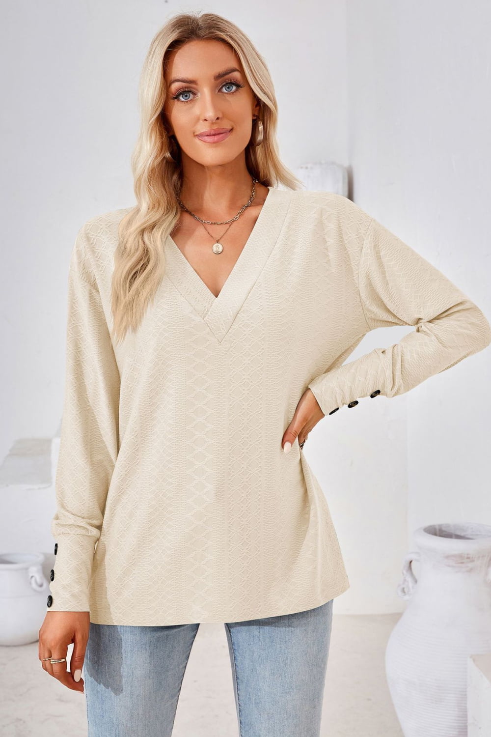 Cream V-neck long-sleeve blouse with diamond texture and relaxed fit