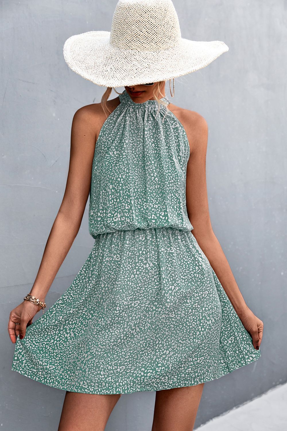 Floral tied sleeveless mini dress in green with halter neckline and full skirt