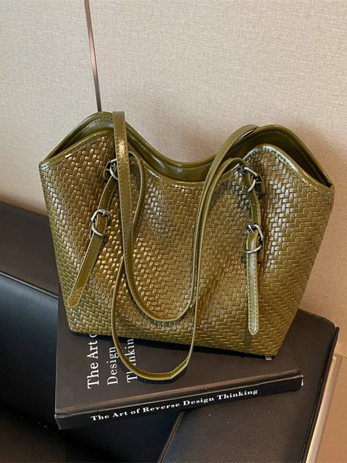 Green textured woven tote bag with two top handles and silver-tone zipper pulls
