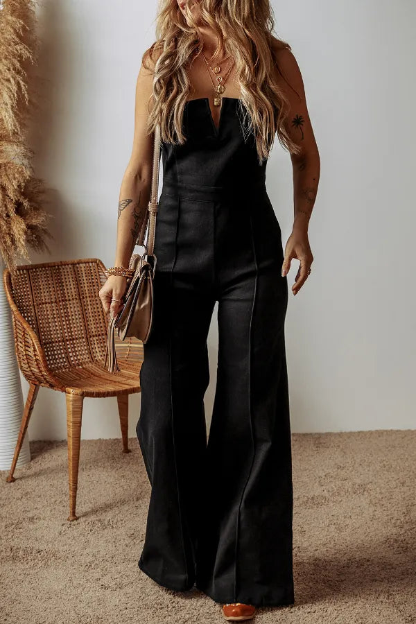 Black denim jumpsuit with spaghetti straps, wide-leg flare and front zip detail