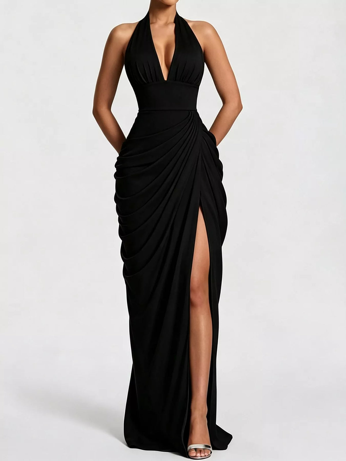 Black halter neck maxi dress with deep V neckline, ruched drape, and high slit