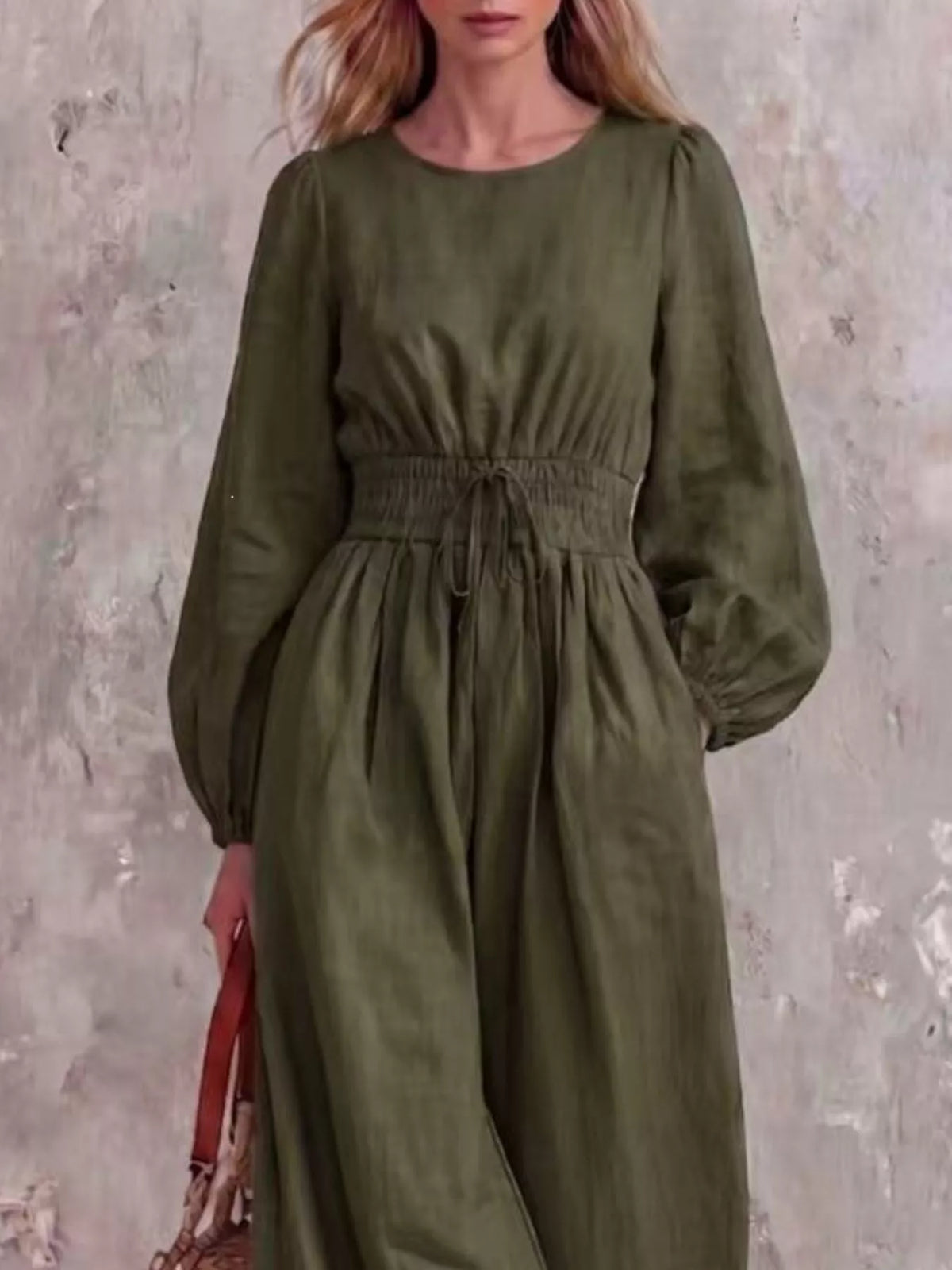 Smocked waist long-sleeve jumpsuit in army green, full-length wide-leg silhouette