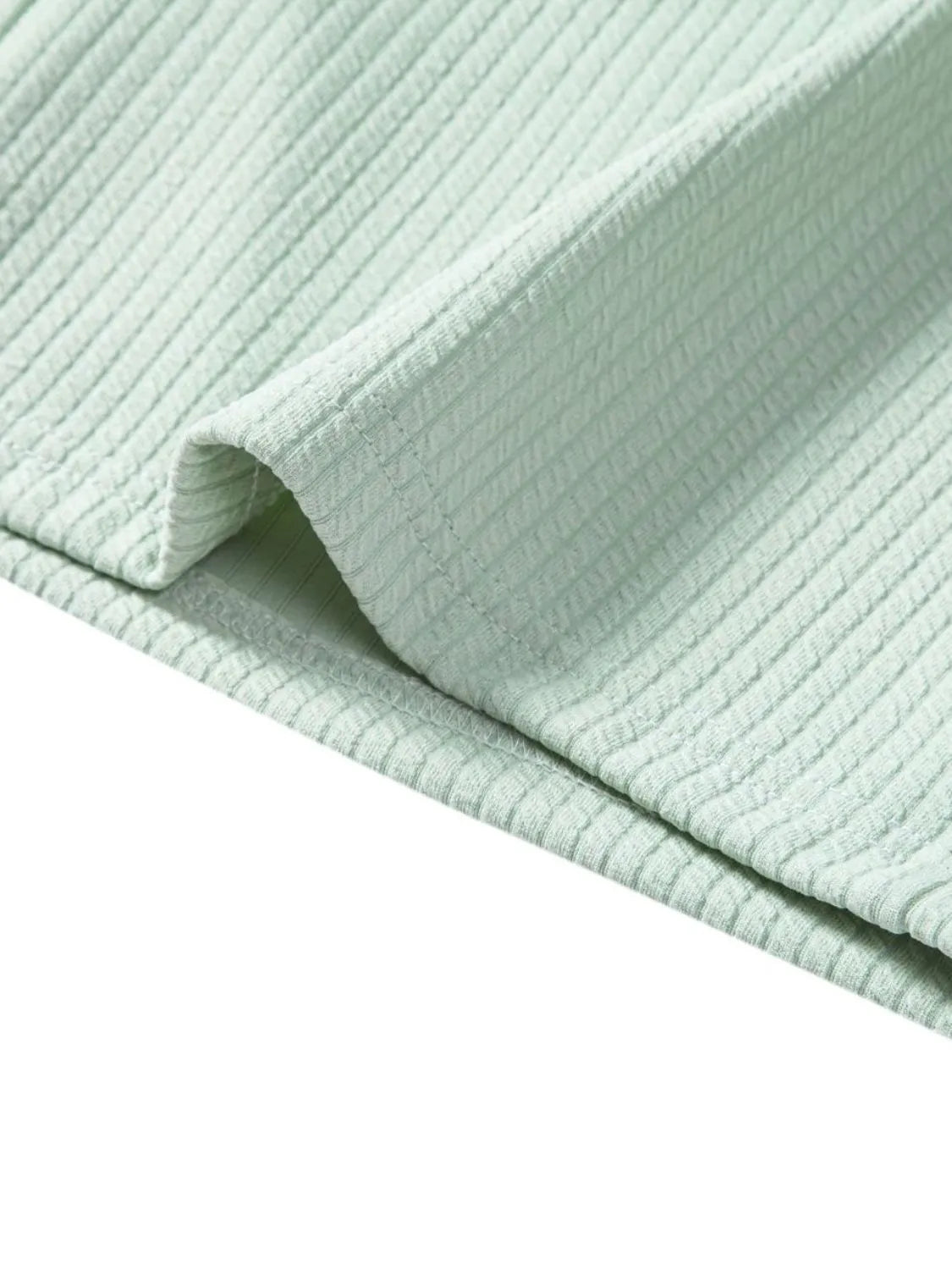 Mint green textured ribbed fabric, folded edge detail