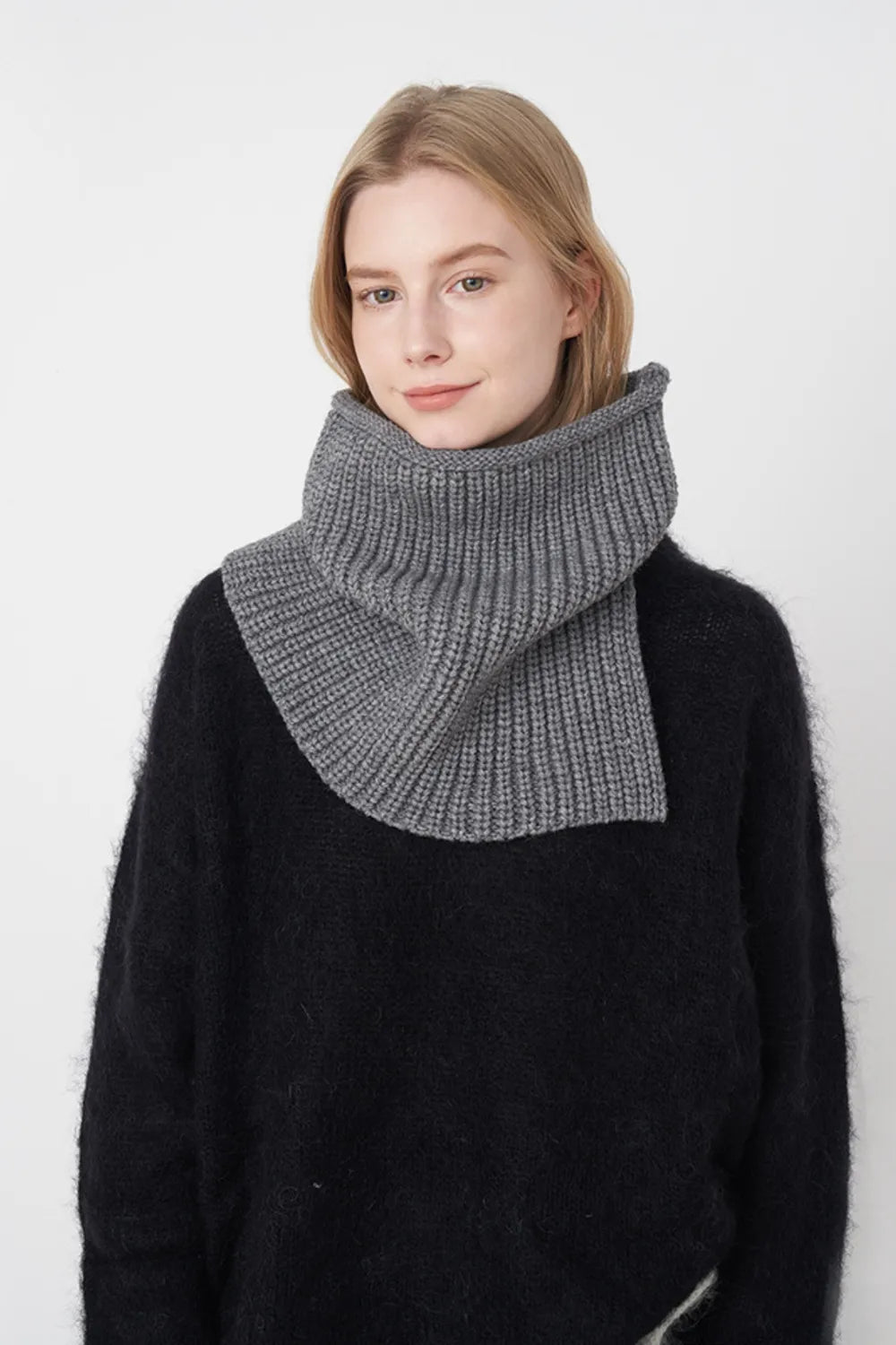 Dark gray ribbed knit pullover scarf worn as folded cowl at the neck