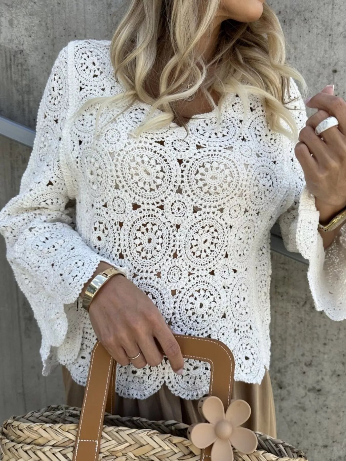 White crochet lace knit top with V-neck and long bell sleeves, patterned front