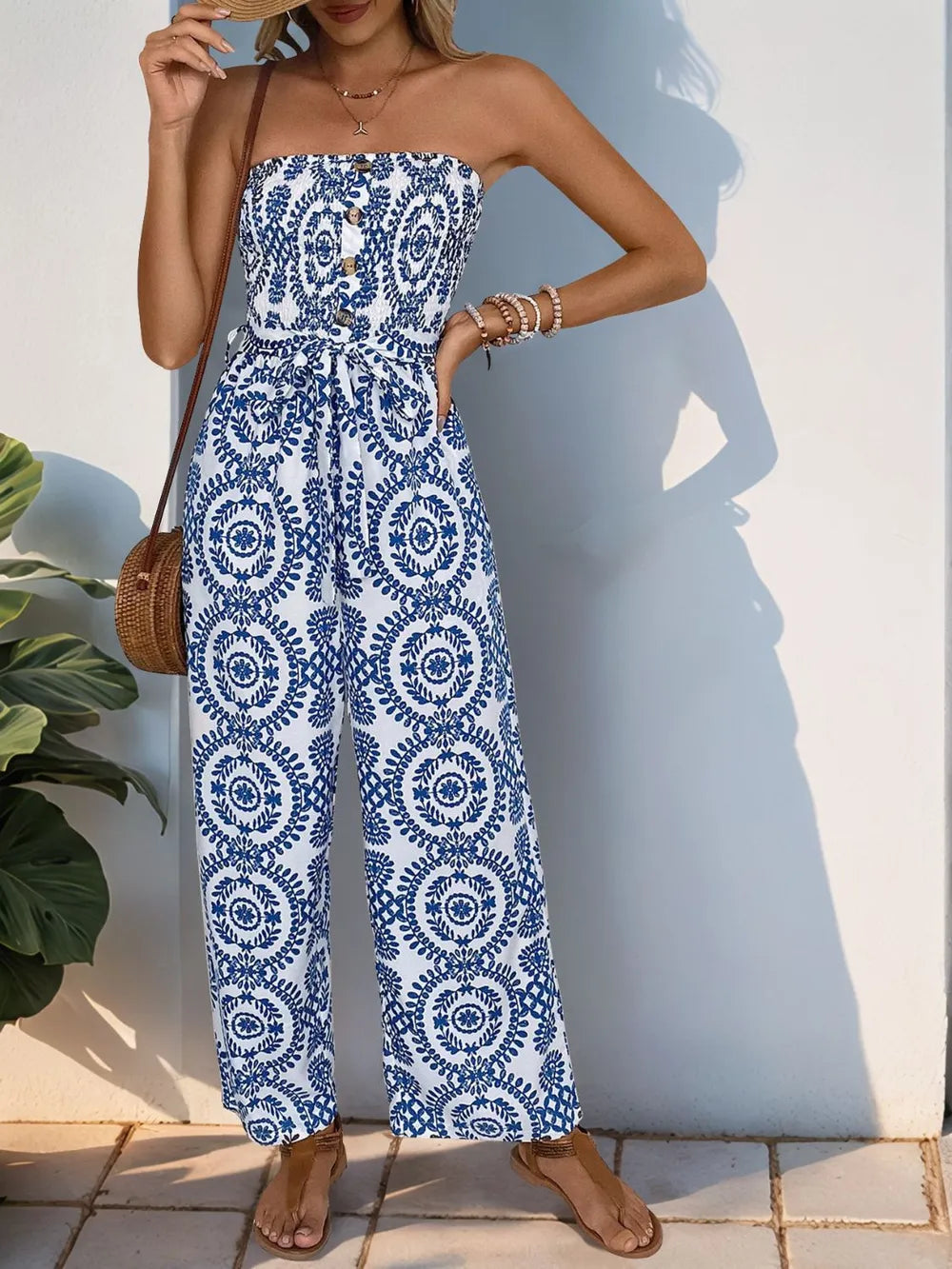 Blue strapless tube jumpsuit with navy medallion print and ruched smocked bodice