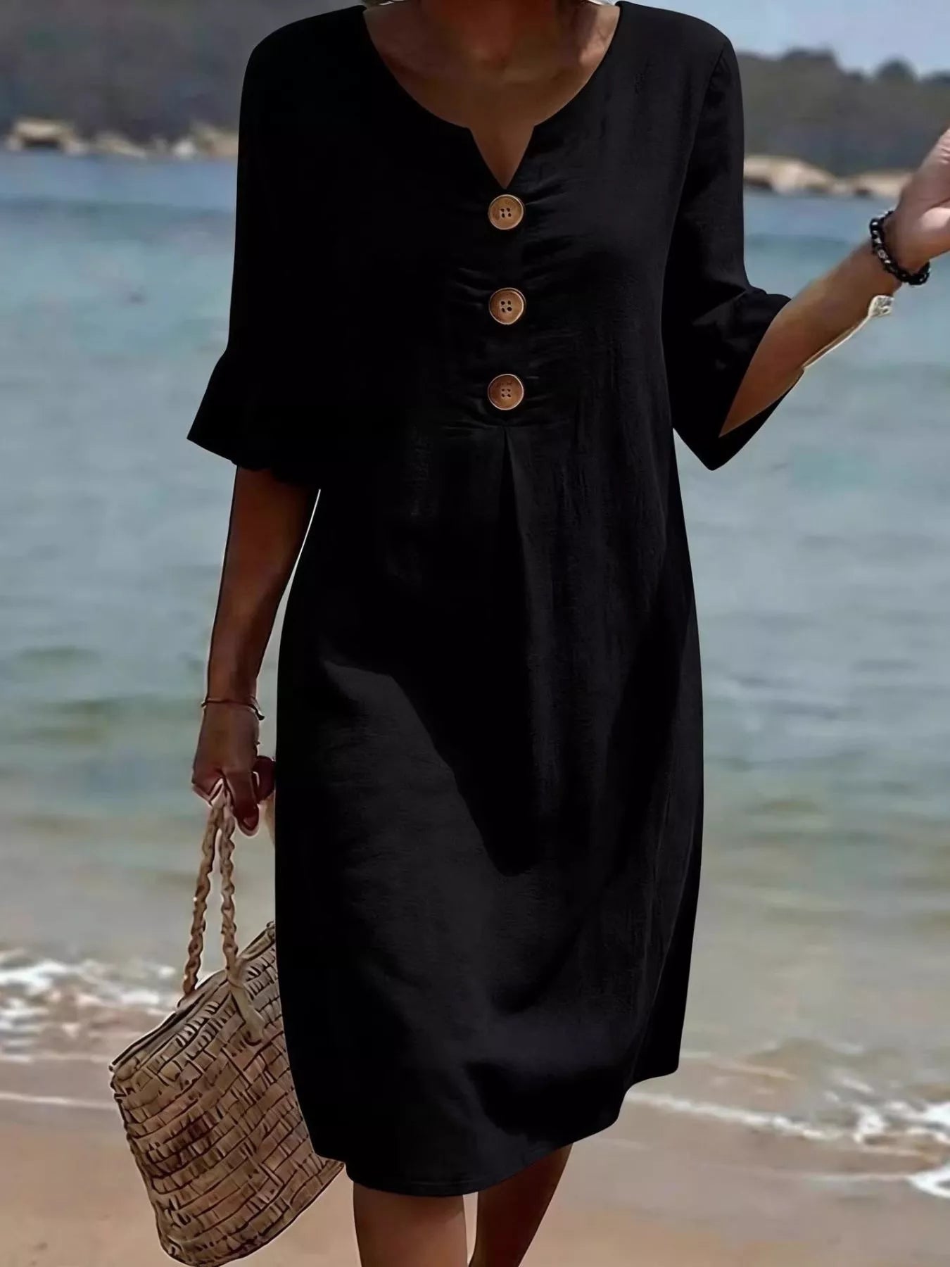 Black midi dress with button placket and flared ruffle sleeves