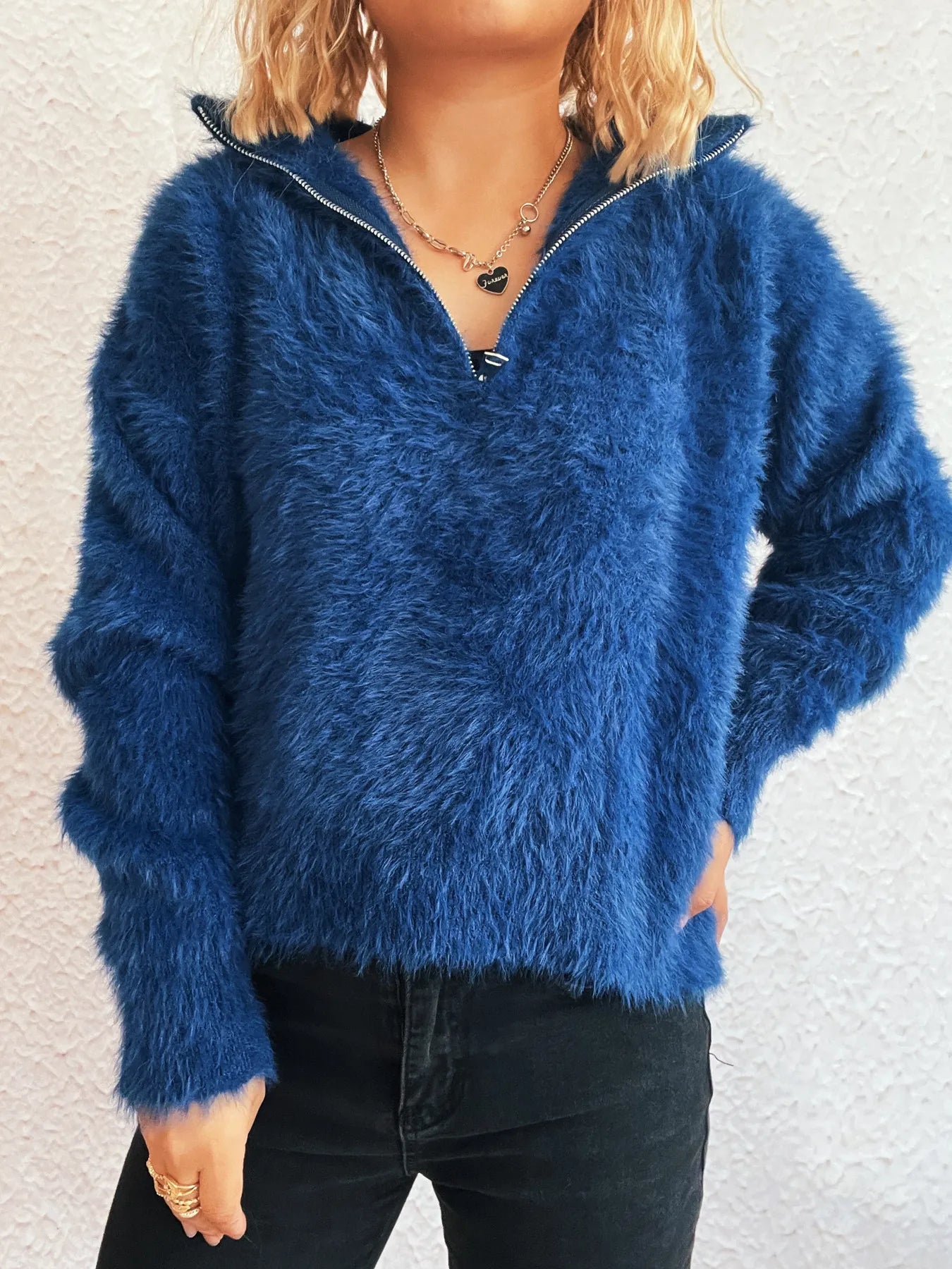 Blue fuzzy half-zip sweater with long sleeves and V-neck placket