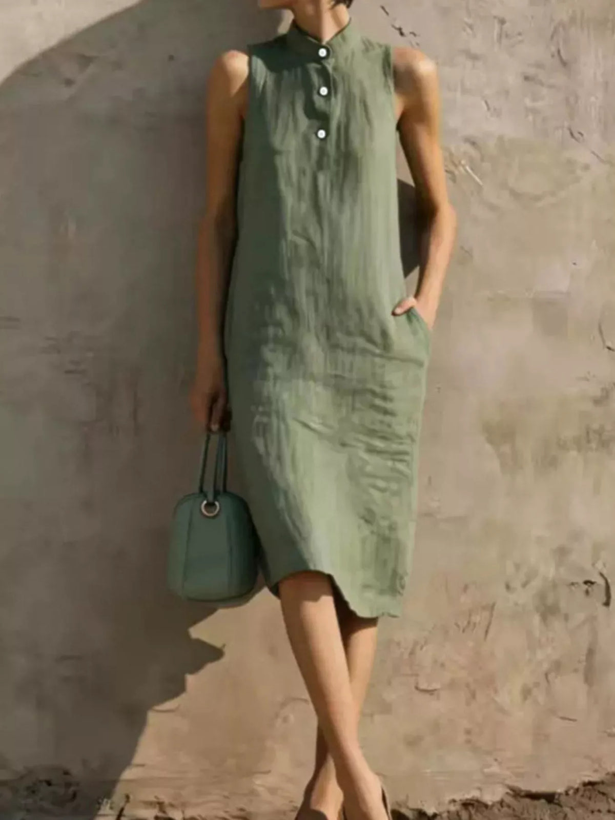 Muted green sleeveless midi dress with button front and side pocket