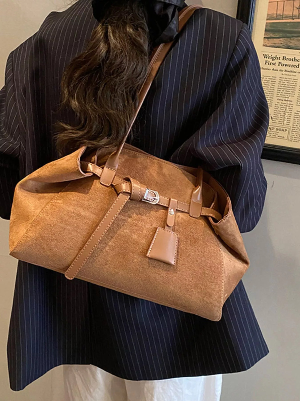 Brown suede buckle shoulder bag with double buckled straps and front square patch