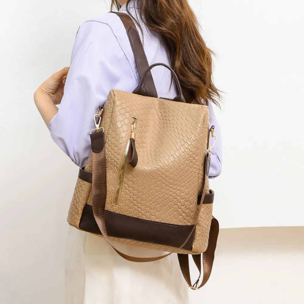 Vegan leather backpack bag in tan with braided texture, front zipper pocket, and shoulder straps.