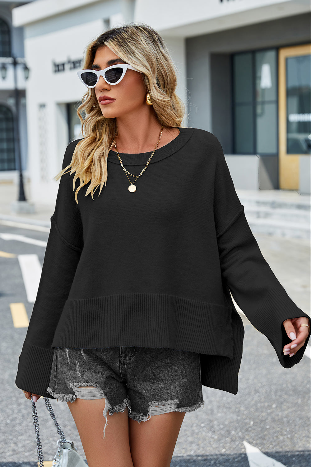 Black dropped-shoulder sweater with ribbed hem and flared sleeves