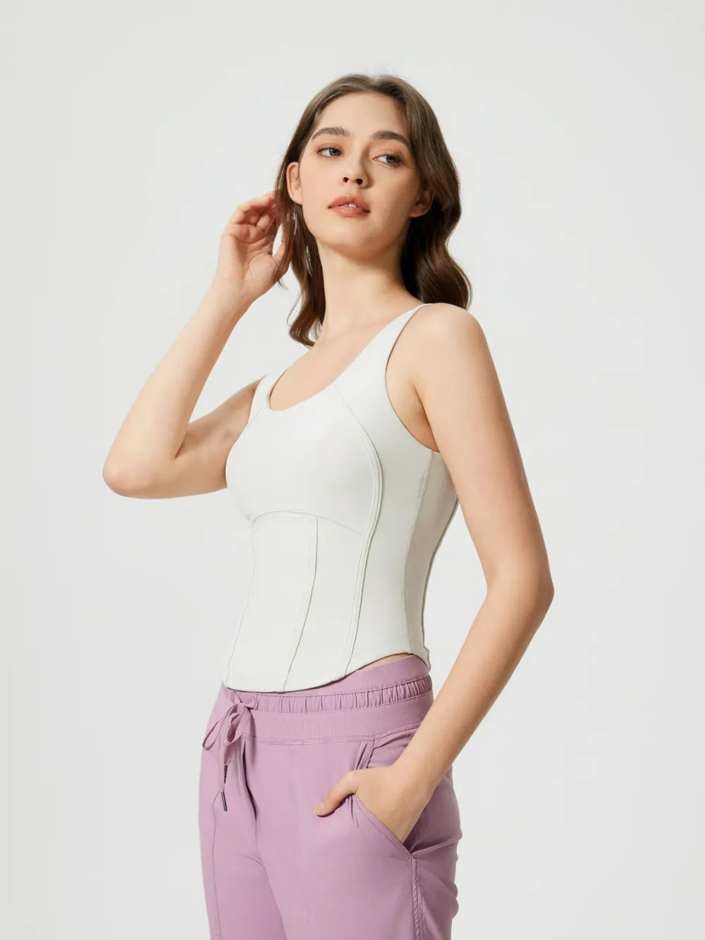 White round-neck active tank with wide straps and curved bust seams