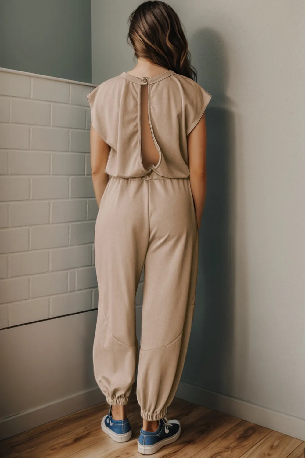 Khaki jumpsuit, open back with ties, gathered waist and ankle cuffs