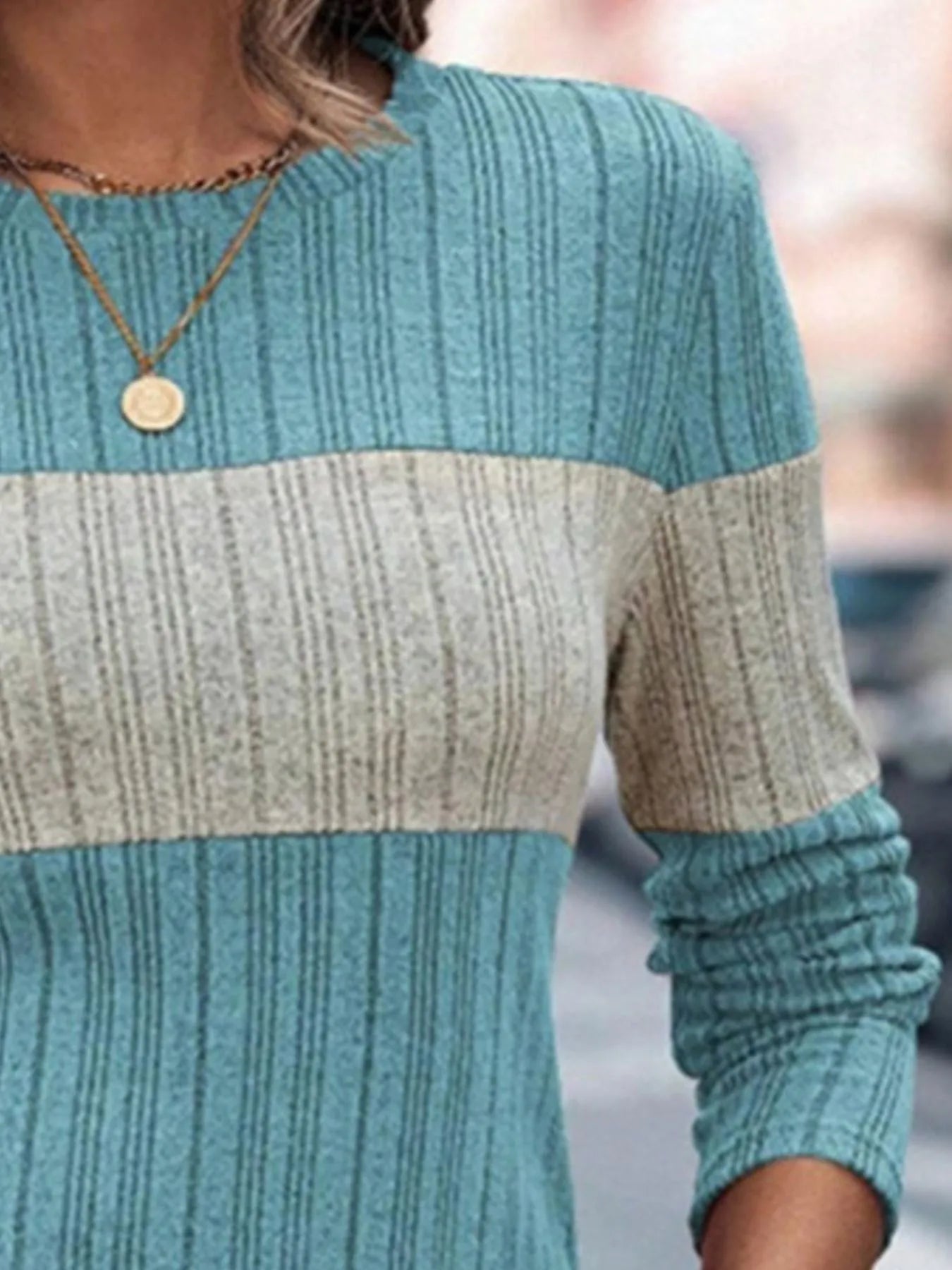 Color-block knit sweater with teal sleeves and heathered cream center band