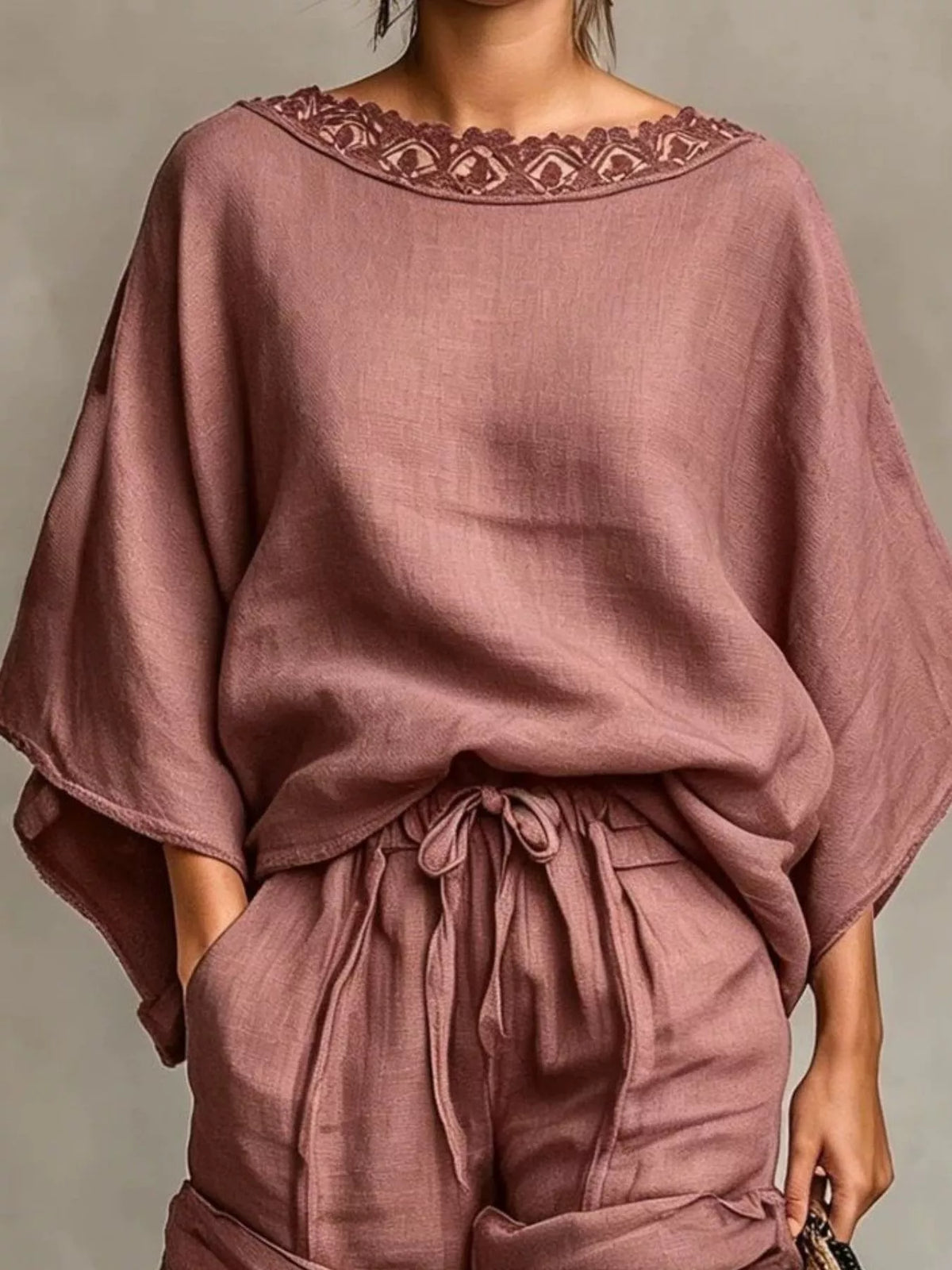 Dusty pink oversized lace neckline top with gathered drawstring shorts, close portrait